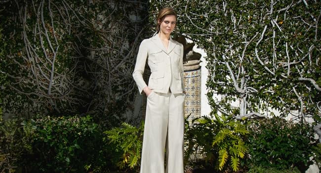 Model in a linen suit standing in a garden