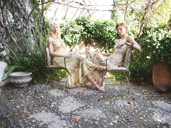 Models sitting in a garden with patterned dresses