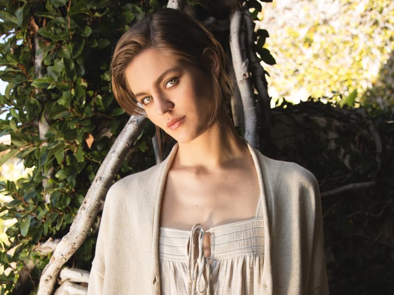 Model standing in designer linen coat, blouse, and pants